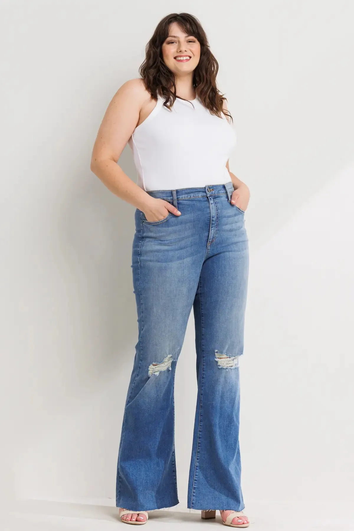 PLUS HIGH RISE DISTRESSED MEDIUM DENIM FLARES WITH RAW HEM